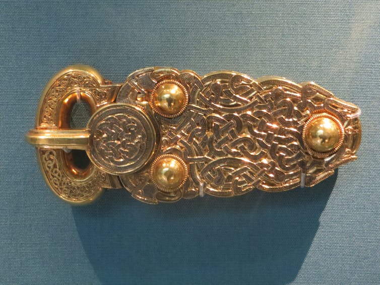 An ornate golden belt buckle