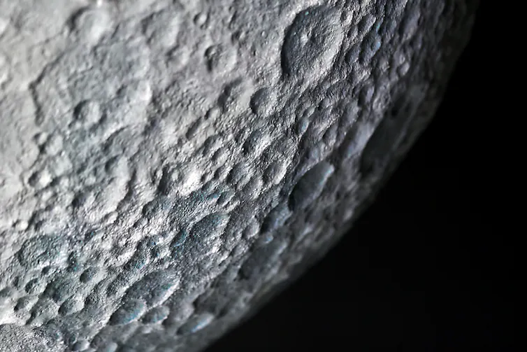 A close up image of craters on the surface of the moon.