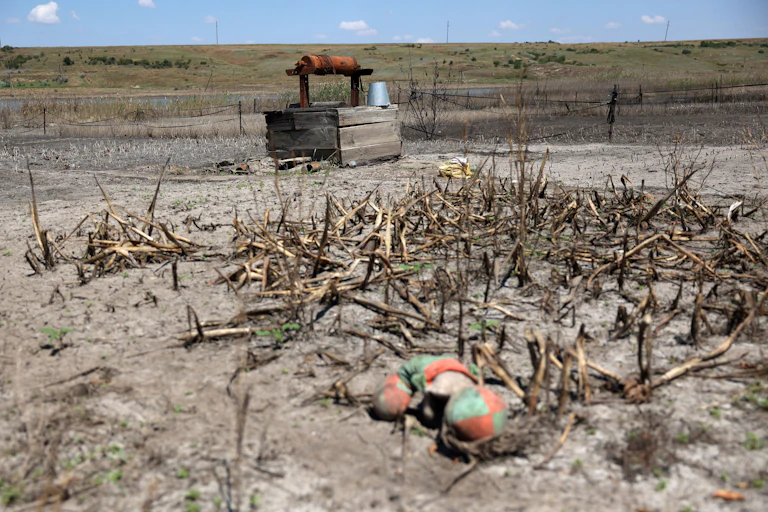 A crude well on a dried dirt plain