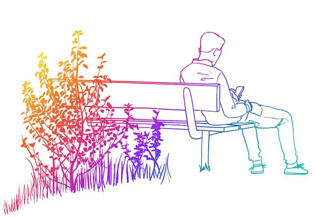 Rainbow colored line drawing of man sitting on a bench in front of foliage while looking at his smartphone.