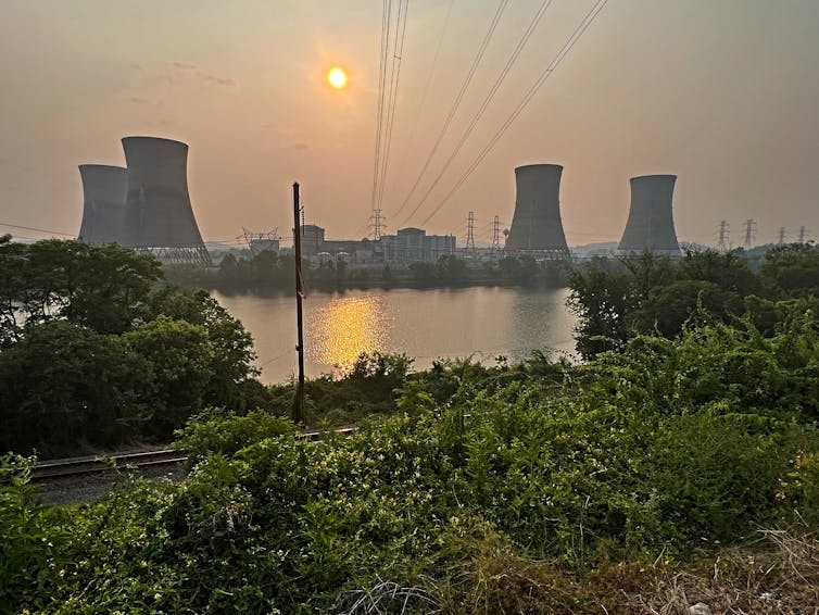 four cooling towers of a nuclear power plant in the distance