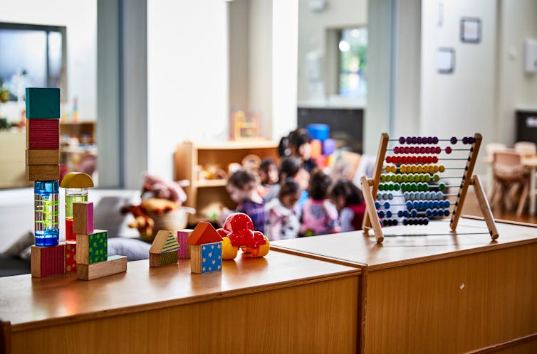 A room in a childcare centre, with toys and shelves.