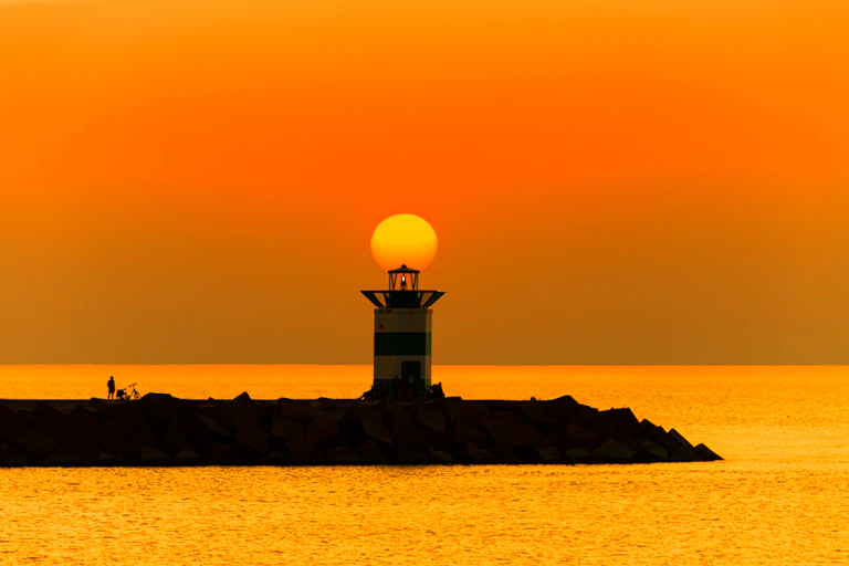 Sunset on the lighthouse of Scheveningen harbor at the summer hottest day ever, Netherlands