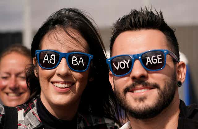 Fans seen wearing sunglasses that say ABBA voyage on the lenses.