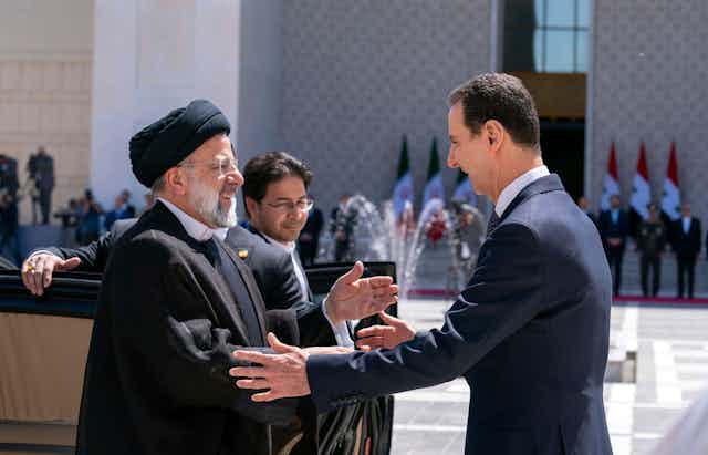 Syrian president Bashar al-Assad greets Iranian president Ebrahim Raisi in Damascus, May 2023