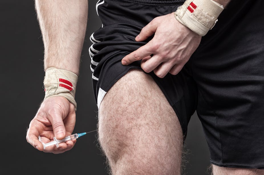 man injects himself in upper thigh.