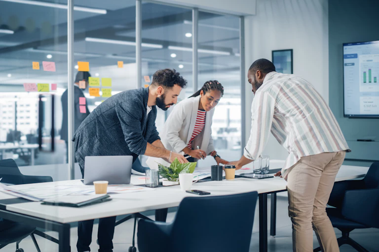 Three employees work in an office room.