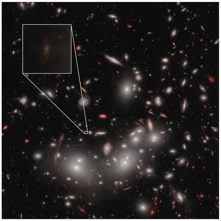 Bright lights (galaxies and a few stars) against a dark backdrop of sky. One faint galaxy is shown in a magnified box as a dim smudge.
