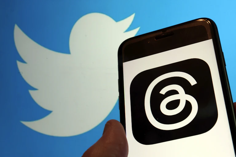 a phone screen displaying a serpentine line on a black square, a white cartoon bird silhouette on a blue background behind the phone