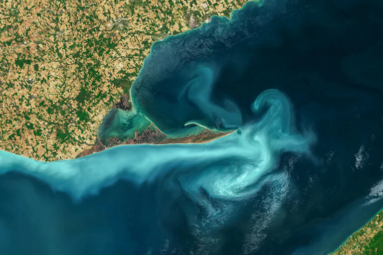 The Great Lakes, Aerial turquoise ocean photo from clear sky, top view of sea texture background, 16:9 ratio wallpaper, blooms of phytoplankton in Great Lakes. Elements of this image furnished by NASA