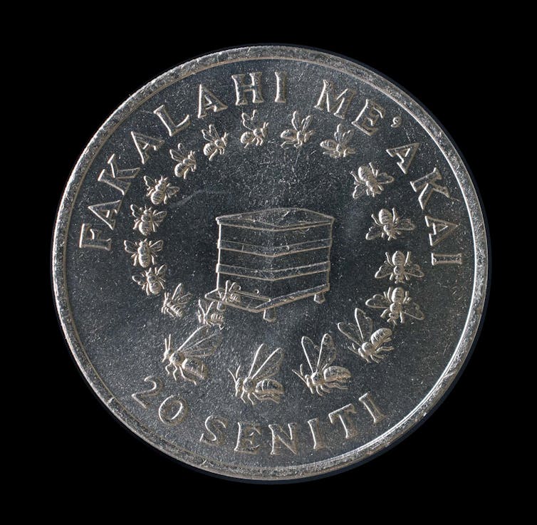 A coin from Tonga showing 20 honeybees emerging from a hive.