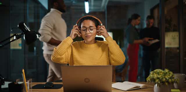 Woman wearing headphones as she works