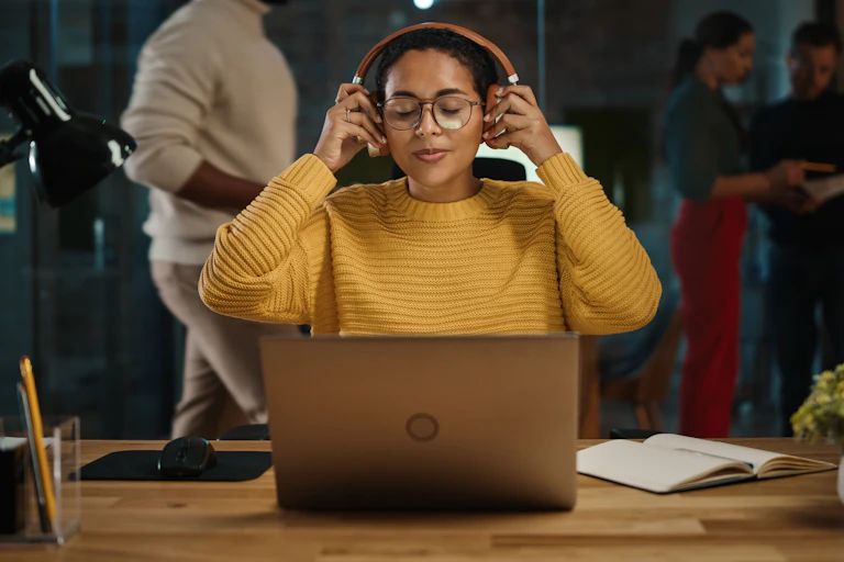 Woman wearing headphones as she works