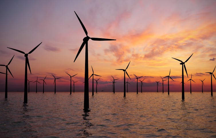 Wind turbines in the sea at dusk