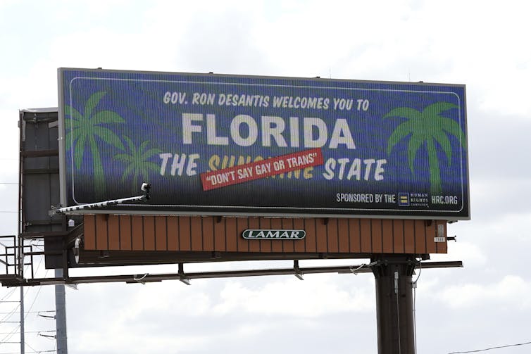 A billboard advertising Florida as the 'Sunshine State,' but with 'on't say gay or trans' superimposed on the word 'sunshine.'