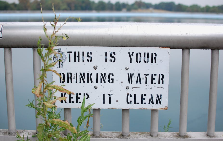 photo of sign saying this is your drinking water, keep it clean in front of reservoir