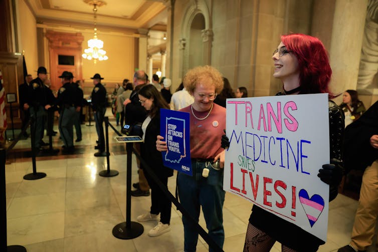 A protester inside the Indiana Statehouse advocating against passage of a bill banning gender transition procedures for minors.