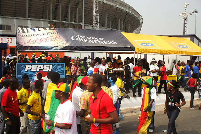 A crowd wearing colourful clothes in the streets