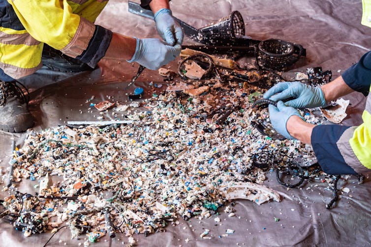 hands sorting plastic debris