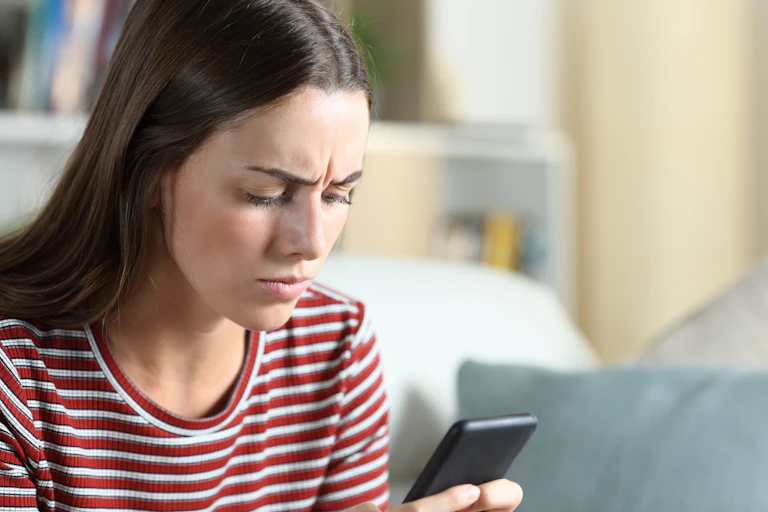 Woman looking at smartphone.