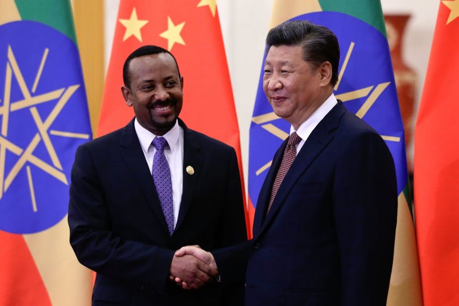 Ethiopia's Prime Minister Abiy Ahmed (left) shakes hands with China's President Xi Jinping