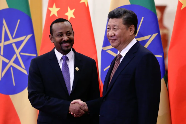 Ethiopia's Prime Minister Abiy Ahmed (left) shakes hands with China's President Xi Jinping