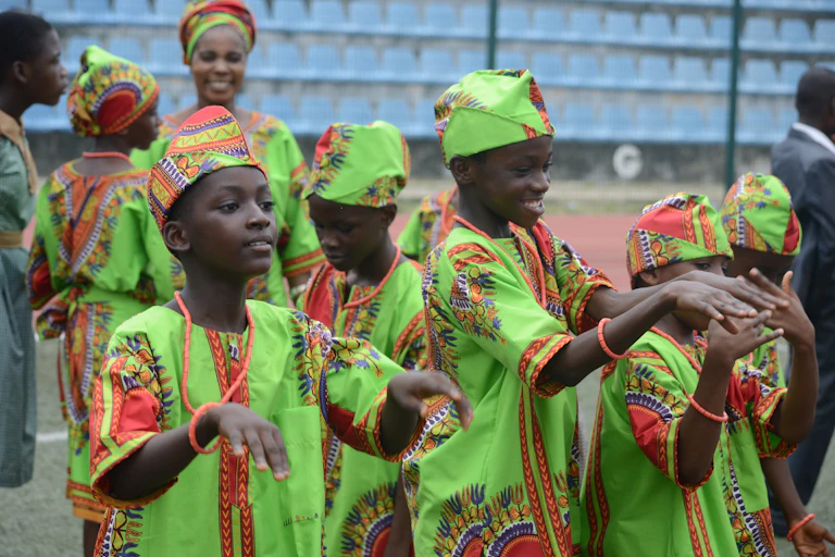Pupils in native attire dance during the Childrens Day parade at Agege Stadium in Lagos Nigeria