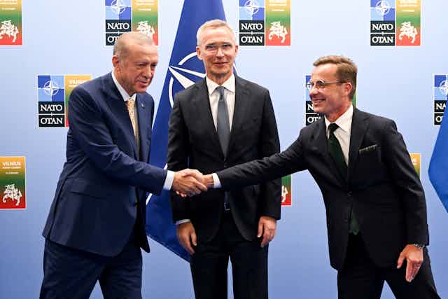 Turkish President Recep Tayyip Erdogan (left) and and Swedish Prime Minister Ulf Kristersson shake hands, as the secretary general of Nato Jens Stoltenberg looks on.