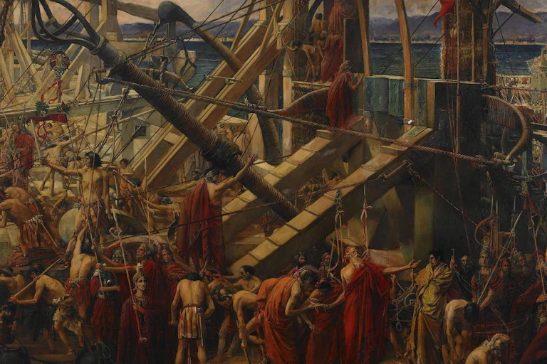 Unos barcos cargan aparatos de defensa en medio de un jaleo de hombres y soldados.