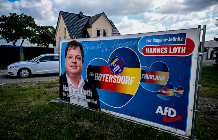 An election poster for Hannes Loth on the verge of a suburban street.
