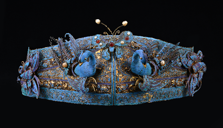 A blue Chinese headdress decorated with blue and gold birds.