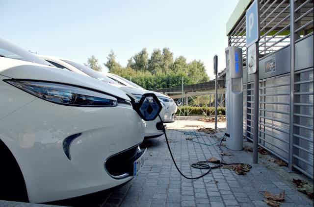 Electric vehicles lined up at a charging station