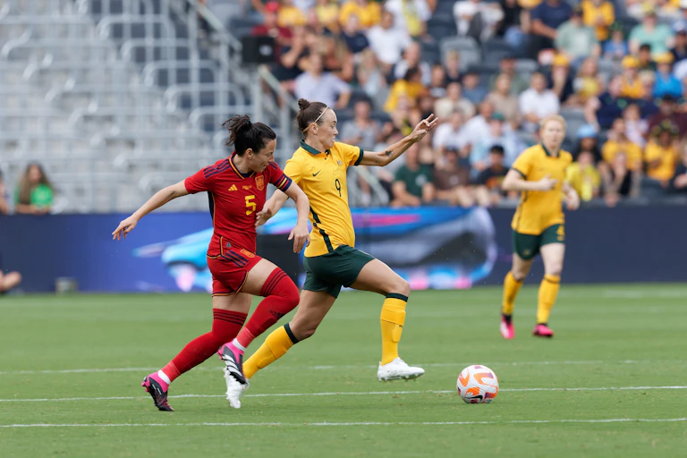 Spanish and Australian female soccer players on field