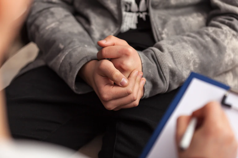 hands of young person and clinician in close up