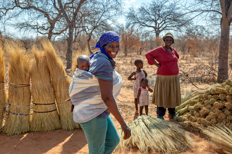 black woman carrying a child on her back