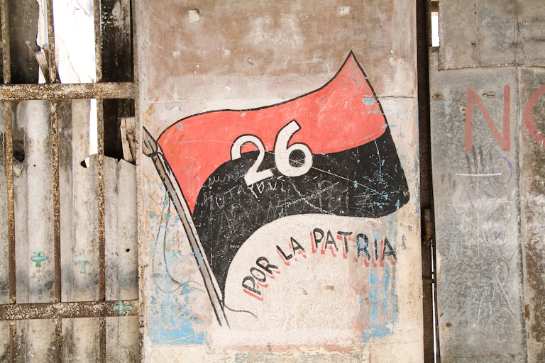 A flag consisting of a red strip and black strip and the white number 26 painted onto the side of a house.