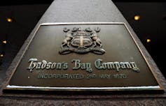 A brass Hudson's Bay Company logo seen outside one of its stores