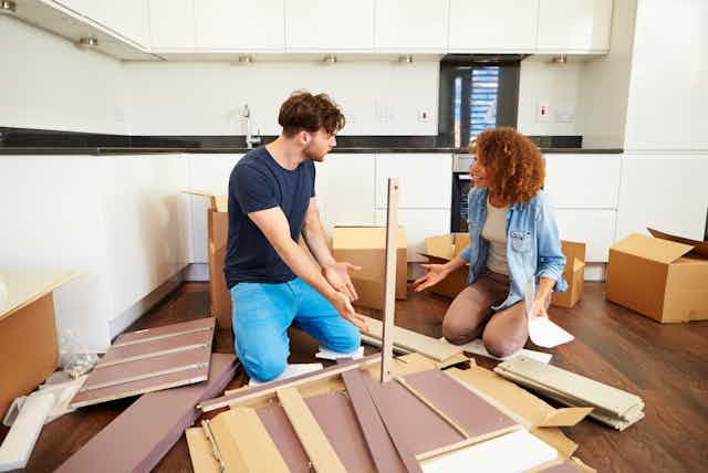 Couple putting together aelf assembly furniture in new home