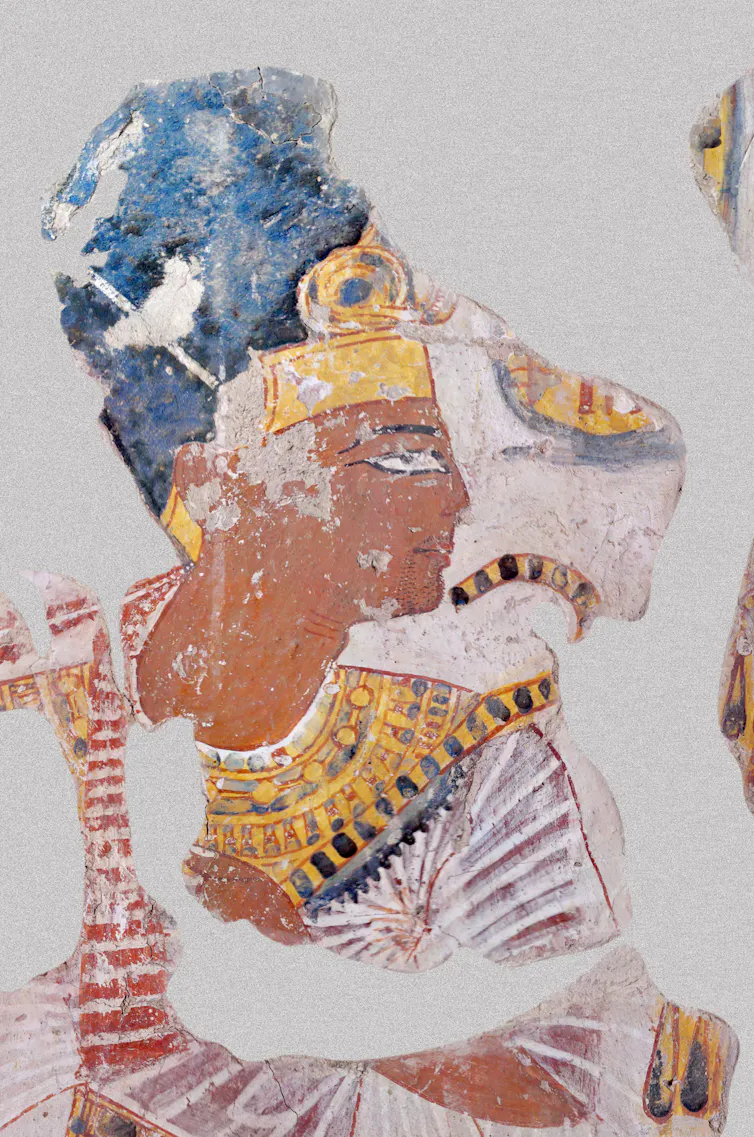 An Egyptian tomb portrait of a Pharoah dressed in blue and gold.