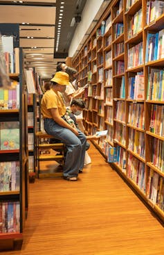 A person seen reading in a bookstore.