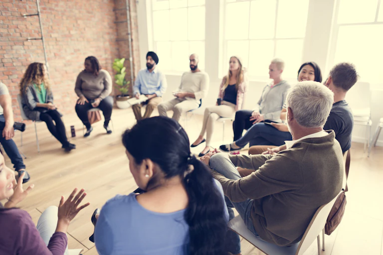 A group of people sitting in a circle.