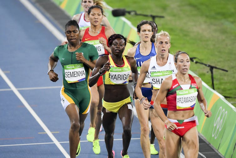 Women running on an athletics track