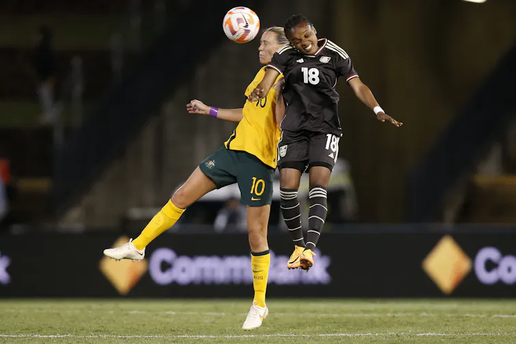 Emily Van Egmond of the Matildas and Trudi Carter of Jamaica compete for a header during the 2023 Cup of Nations women's soccer match