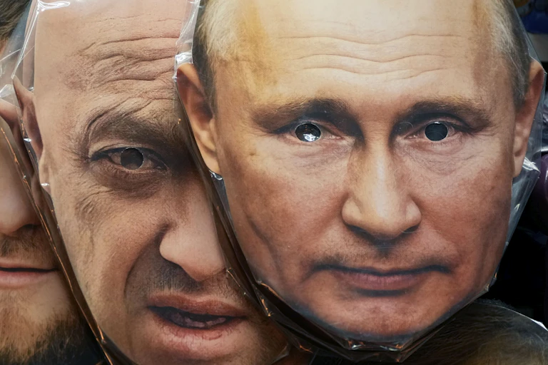 Masks of two men with holes cut out for eyes.