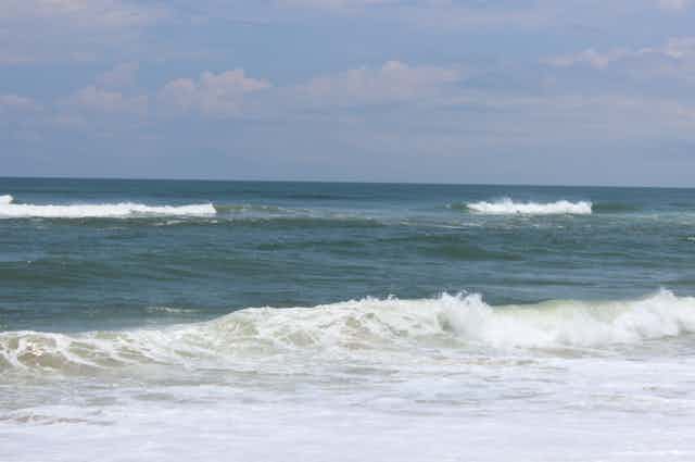 A long wave breaking on a beach with a large gap in its center