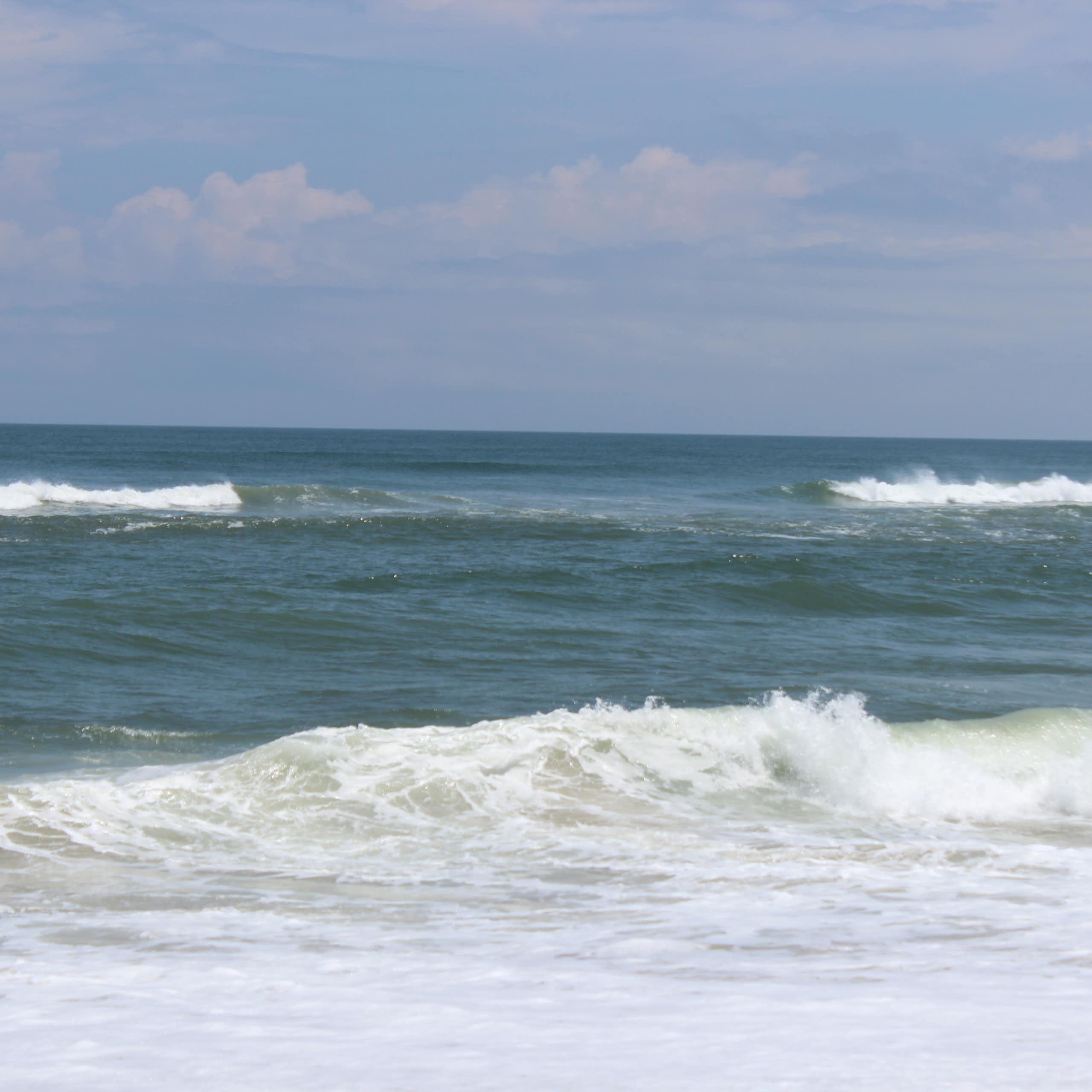 A long wave breaking on a beach with a large gap in its center