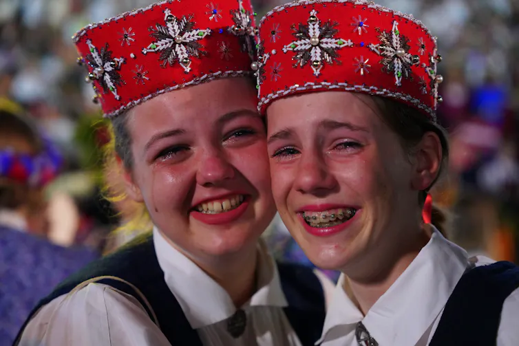 Two teenage girls crying.
