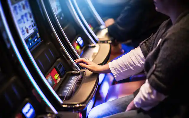 Woman plays a pokie machines