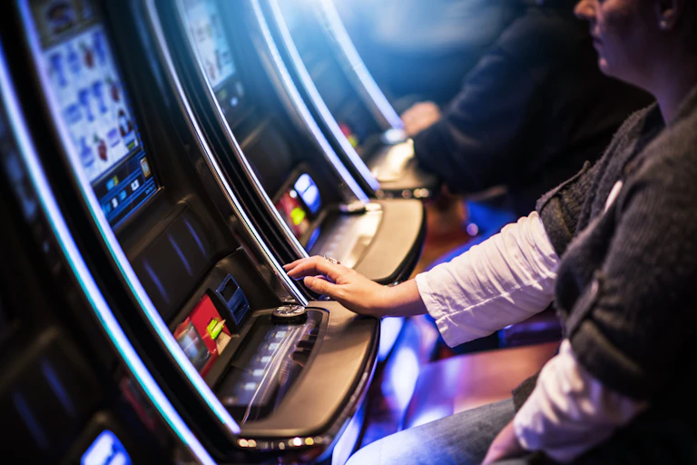 Woman plays a pokie machines