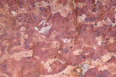zoom on a pink mineral with pinkish and whitish spots